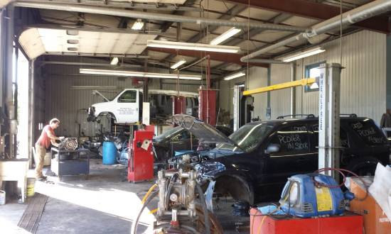 a man working on a car in a garage