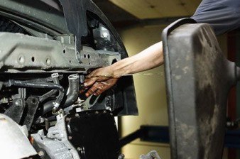 Mechanic working on car engine