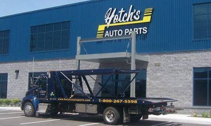 a truck parked in front of a auto parts store