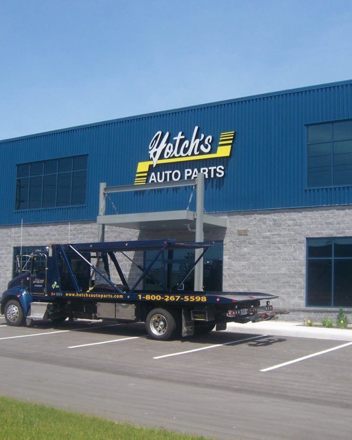 a truck parked in front of a auto parts store