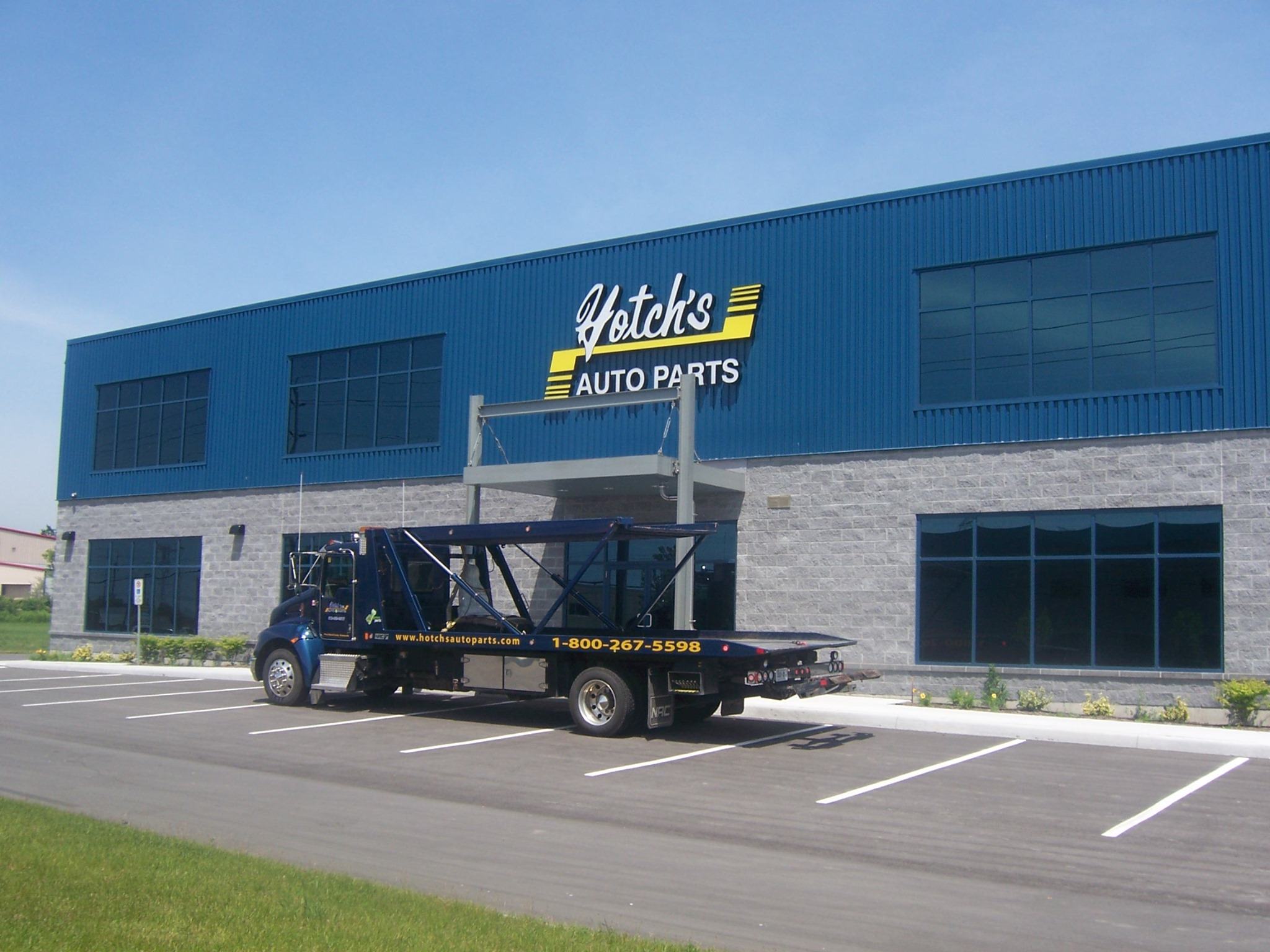a truck parked in front of a auto parts store