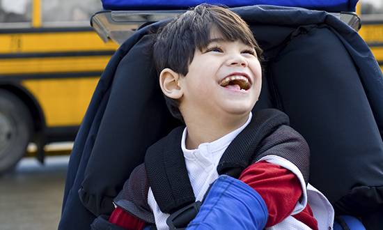 a young boy sitting in a chair with his mouth open